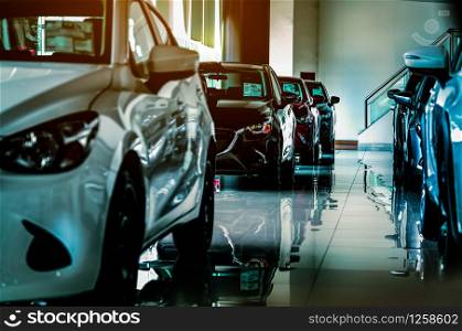 New luxury compact car parked in modern showroom for sale. Car dealership office. Car retail shop.