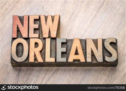New Orleans word abstract in vintage letterpress wood type against grained wooden background