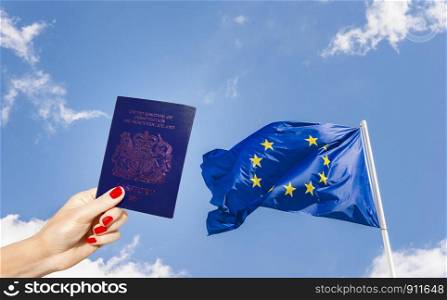 New post-Brexit blue UK passport with European Union flag minus one star against a blue sky. Blue coloured passports will be phased in slowly from 2020. New post-Brexit blue UK passport with European Union flag minus one star against a blue sky