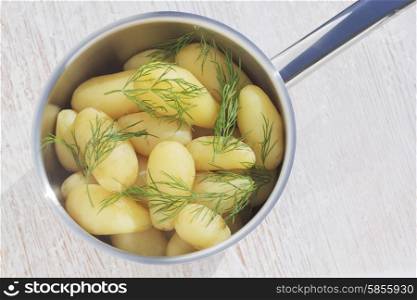 New potatoes with dill in steel pot
