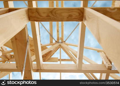 New residential construction home framing against a blue sky.Shallow focus.