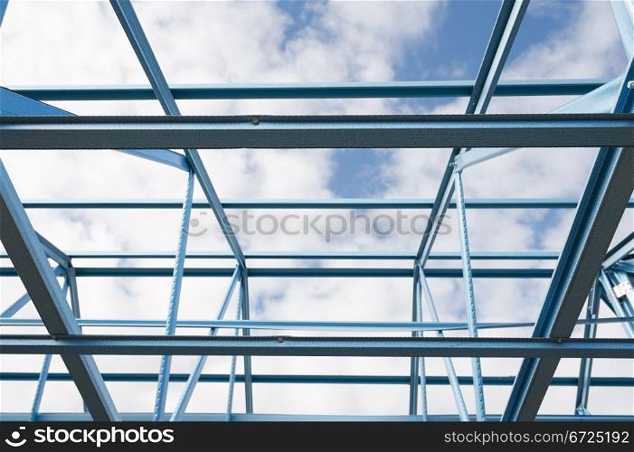 New residential construction home metal framing against a blue sky.Fragment.