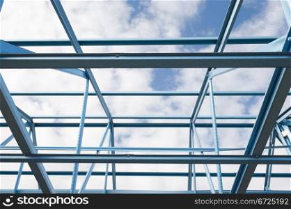 New residential construction home metal framing against a blue sky.Fragment.