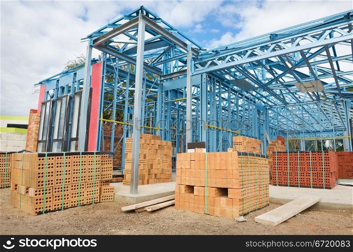 New residential construction home metal framing against the blue sky