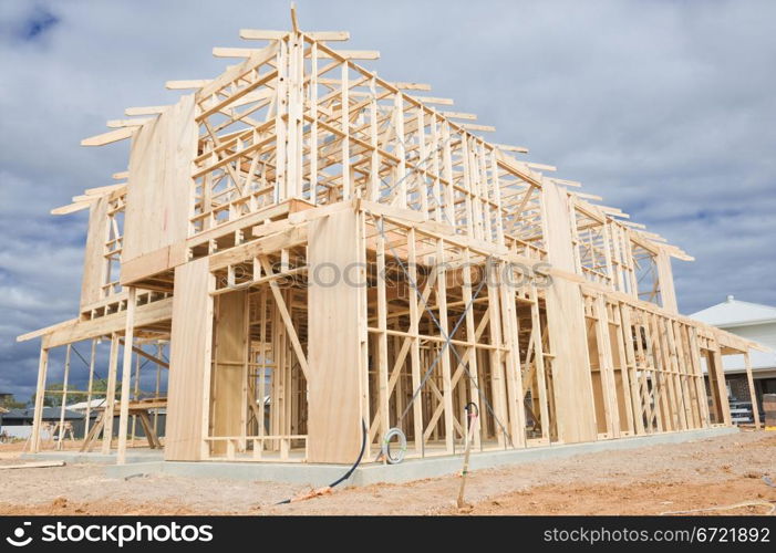 New residential construction home wooden framing against a blue sky