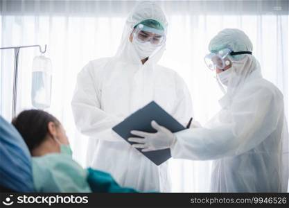 New second pandamic of COVID-19virus speaded. Experts male doctor in PPE suit working with Corona virus infected patient people in hospital quarantine negative pressure room.
