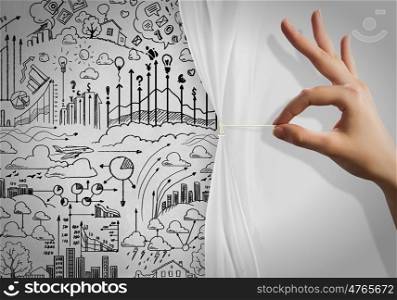 New strategy. Close up of hand opening the white curtain with business sketches behind