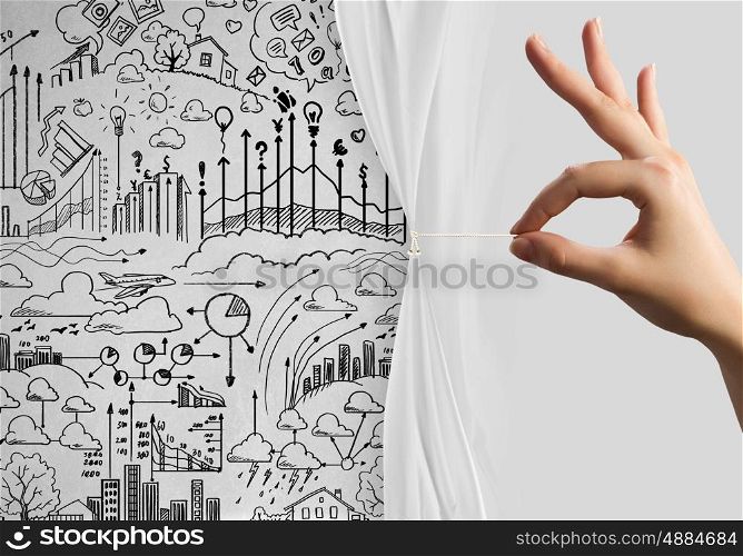 New strategy. Close up of hand opening the white curtain with business sketches behind
