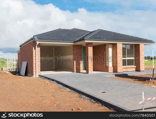 new suburban home currently under construction against cloudy sky