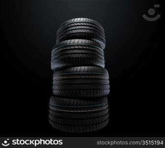 new summer tires stacked, over black, studio shot