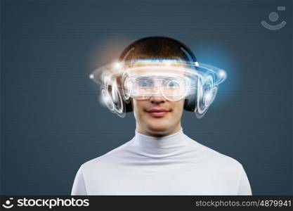 New technologies. Young handsome man against media backdrop wearing headphones