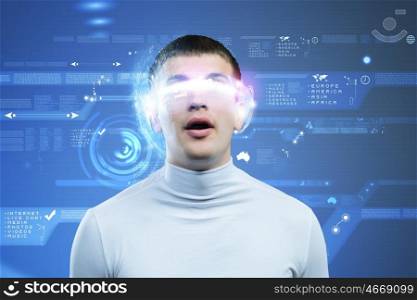 New technologies. Young man in white against blue background with hologram around head