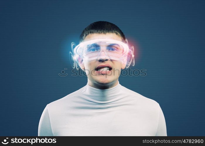 New technologies. Young man in white against blue background with hologram around head