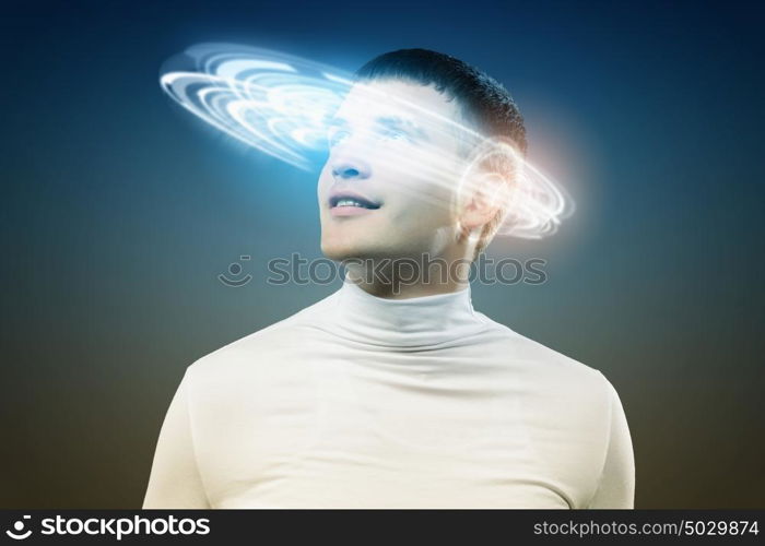 New technologies. Young man in white against blue background with hologram around head