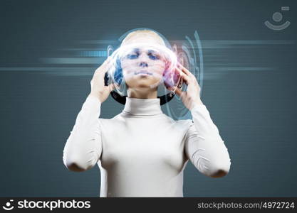 New technologies. Young woman in white against media background wearing headphones