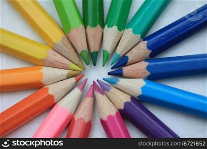 New, unused color pencils making a circle rainbow