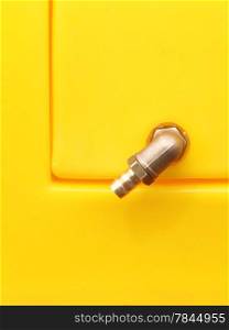 New valve, industrial detail on yellow metal background