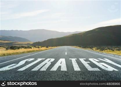 New way for your business. Conceptual image with word strategy on asphalt road