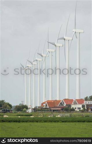 new windmill with a green meadow as foreground