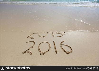 New Year 2016 is coming concept. New Year 2016 is coming concept. Happy New Year 2016 replace 2015 concept on the sea beach