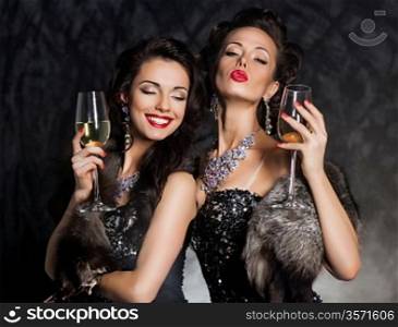 New Year&acute;s Eve of two beautiful young women with wine glasses