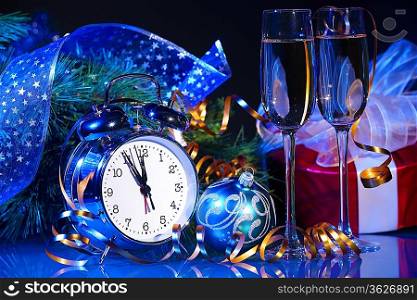 New Year&acute;s still life. Decorations and ribbons on a bright color background