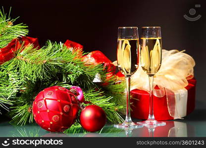 New Year&acute;s still life with glasses of champagne. Decorations and ribbons on a bright color background