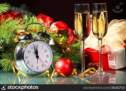 New Year&acute;s still life with glasses of champagne. Decorations and ribbons on a bright color background