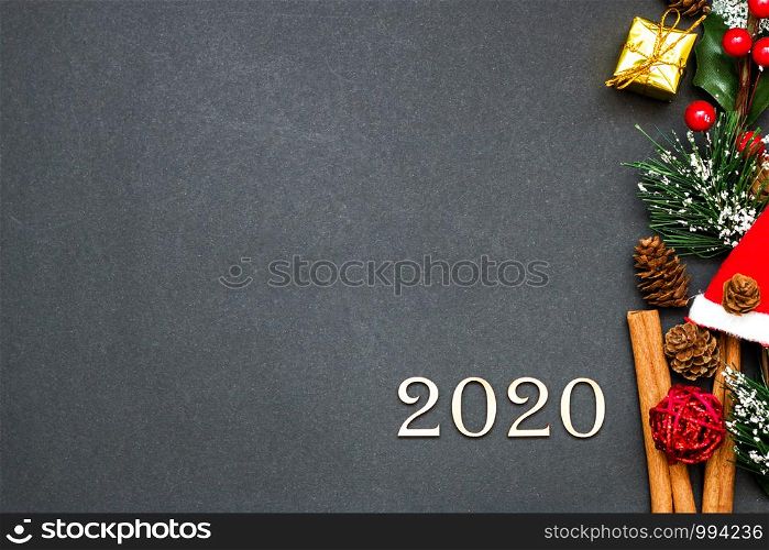 New year and Christmas concept flatlay holiday decorations and figures 2020 on dark background with copy space.. New year and Christmas concept flatlay holiday decorations and figures 2020 on dark background with copy space