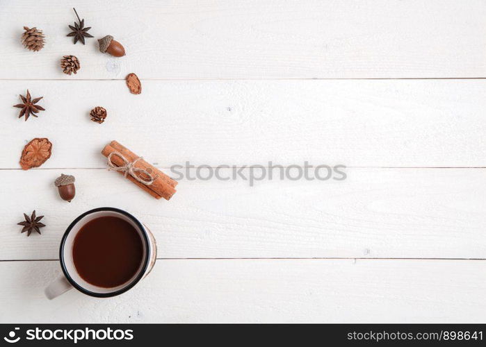 new year background. cinnamon,anise stars,fir branches and a Cup of hot chocolate on a white wooden background. Flat lay. top view