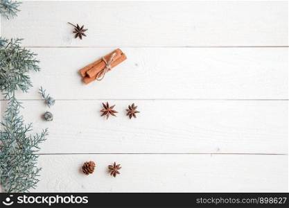 new year background. flatlay. cinnamon,anise and spruce branches on white wooden background