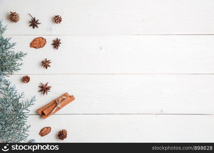 new year background. flatlay. cinnamon,anise and spruce branches on white wooden background