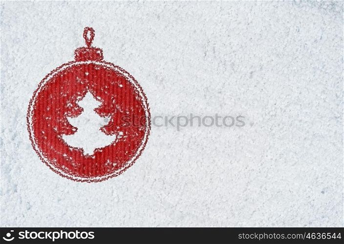 new year background on snow. christmas card or new year background made of decorative ball symbol handwritten on snow and red craft paper