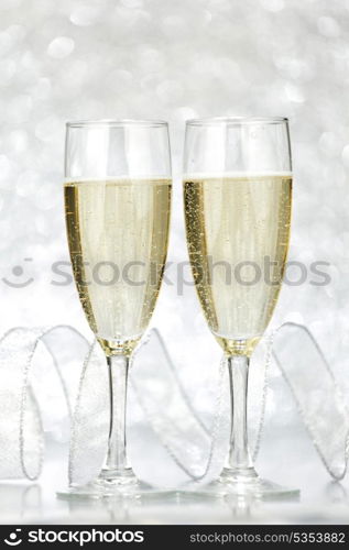 New year card with Champagne on shiny glitter background