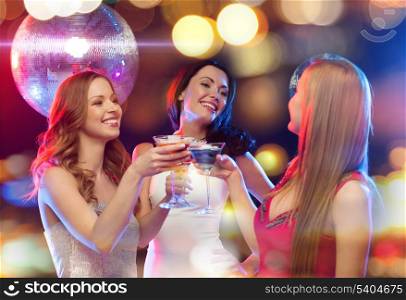 new year, celebration, friends, bachelorette party, birthday concept - three women in evening dresses with cocktails and disco ball
