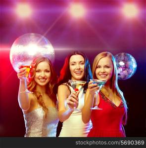 new year celebration, friends, bachelorette party, birthday concept - three women in evening dresses with cocktails and disco ball
