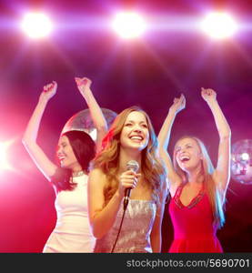 new year, celebration, friends, bachelorette party, birthday concept - three women in evening dresses dancing and singing karaoke