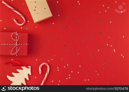New Year Christmas presents wrapped ribbon flat lay top view Xmas holiday 2019 celebration handmade gift boxes red paper golden sparkles background copyspace. Template mockup greeting card text design
