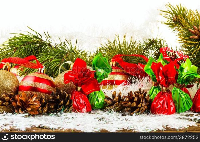New Year Christmas-tree background with pine cone, christmas ball and candies