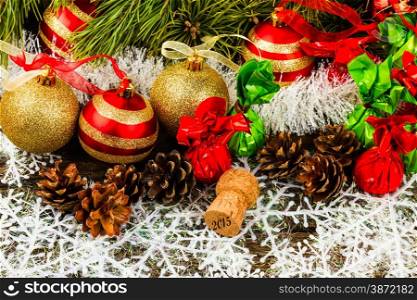 New Year Christmas-tree background with pine cone, christmas ball, champagne corks and candies