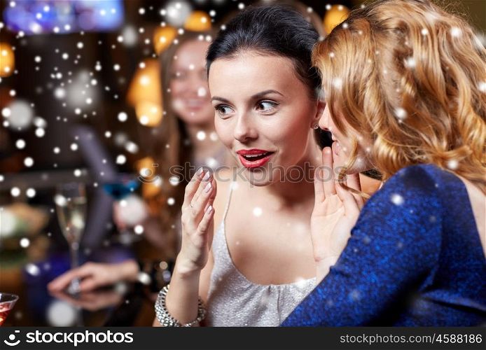 new year, christmas, winter holidays and people concept - happy women gossiping at night club over snow