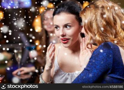 new year, christmas, winter holidays and people concept - happy women gossiping at night club over snow
