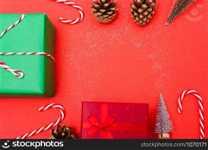 New Year, Christmas Xmas holiday composition, Top view green and red gift box, clews of rope, green fir tree branch on red background with copy space