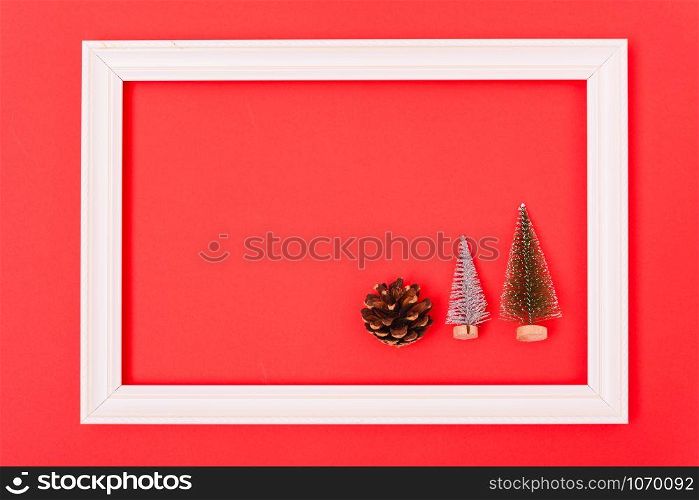 New Year, Christmas Xmas holiday composition, Top view green fir tree branch in frame on red background with copy space