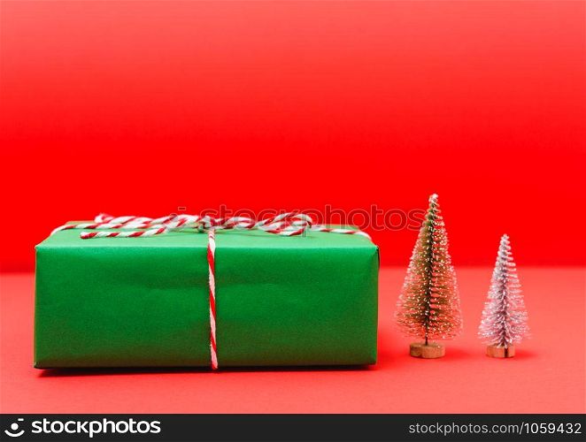 New Year, Christmas Xmas holiday composition, Top view green gift box and green fir tree branch on red background