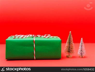 New Year, Christmas Xmas holiday composition, Top view green gift box and green fir tree branch on red background