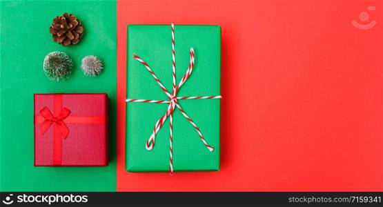 New Year, Christmas Xmas holiday composition, Top view with gift box, clews of rope, green fir tree branch on red and green background with copy space