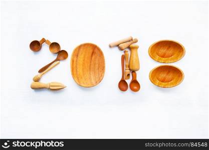 New Year concept for 2018 : Wooden cook's tools idea numbers on white background.