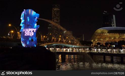 New Year Countdown 2019 at Merlion with colorful lights in Downtown Singapore City at night with skyscraper buildings background