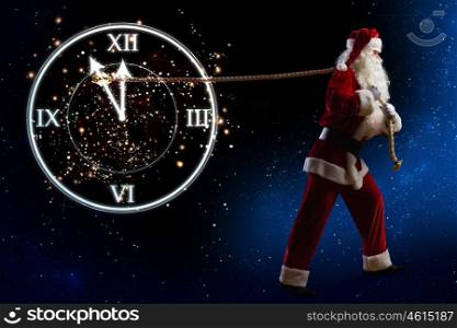 New Year Eve. Santa Claus and clock showing five minutes to twelve